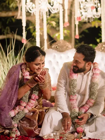 A candid, happy moment between the couple during their traditional Bunt wedding rituals.