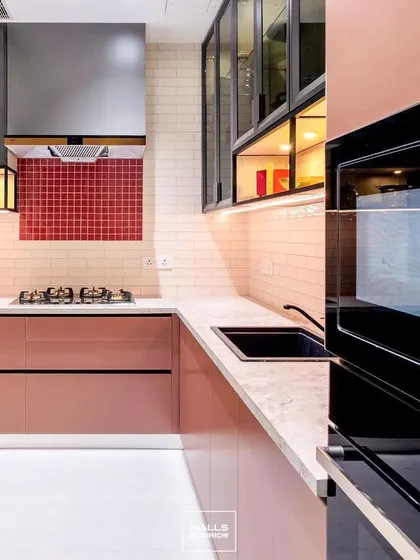 This angle highlights the kitchen's practical layout, with the built-in oven at a convenient height and ample counter space next to the hob. The under-cabinet lighting illuminates the workspace perfectly.