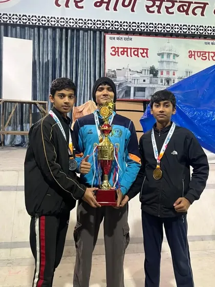 Three of my champions with their medals and the team trophy. Their collective effort brought us this victory.
