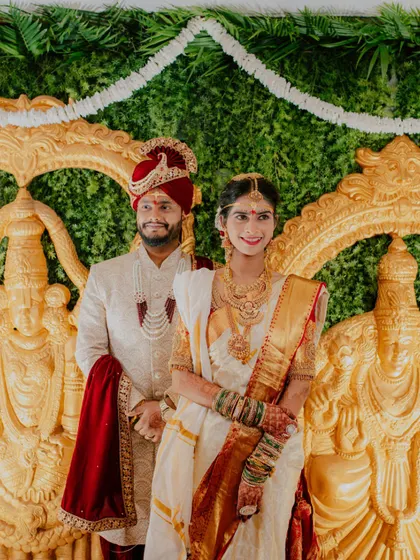 A beautiful formal portrait of the couple, showcasing their coordinated wedding outfits.