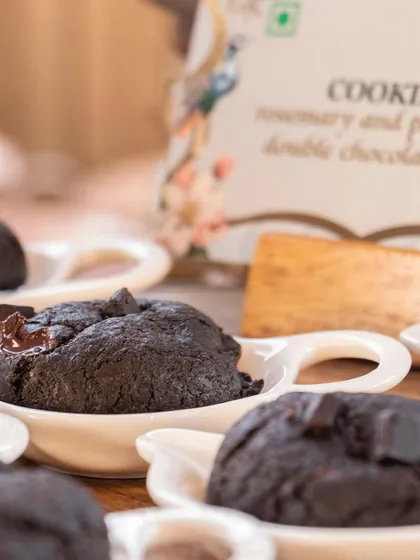 Sinful double chocolate chip cookies, soft and chewy, served in individual ceramic dishes.
