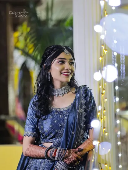 A lovely portrait of the bride smiling, with a backdrop of twinkling fairy lights.