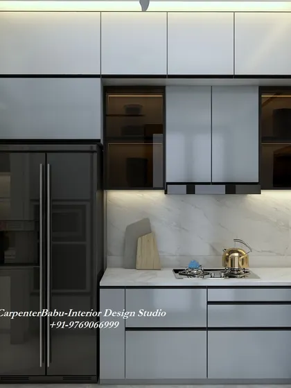 A modern kitchen with grey cabinets and a built-in refrigerator and oven. The design is sleek and efficient, with a marble-finish backsplash adding a touch of luxury.