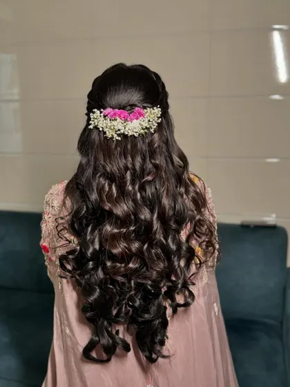 A closer look at the floral hair accessory, which adds a touch of natural beauty and romance to her Roka hairstyle.