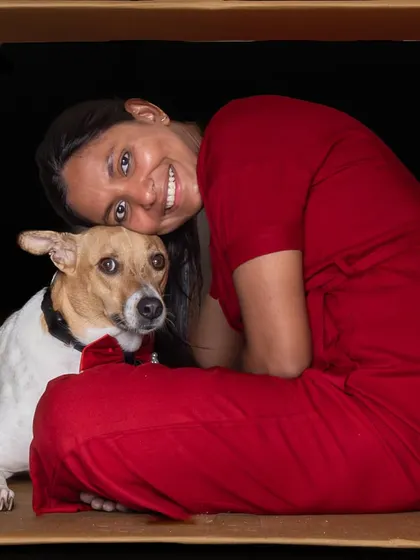 A quiet, loving moment between a pet parent and her dog, captured in a creative "in the box" studio session.