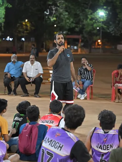 An organizer addresses the young players before the awards ceremony, sharing words of encouragement.