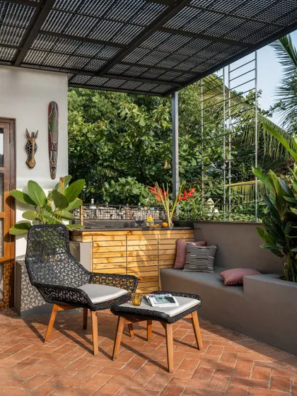 The terrace is the soul of our home, designed as an urban oasis with built-in seating, a small bar, and lots of plants.