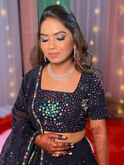 All set for a Rajasthani night! I created a dramatic blue smokey eye to complement the colorful mirror work on her black lehenga, a perfect fusion of traditional and modern.