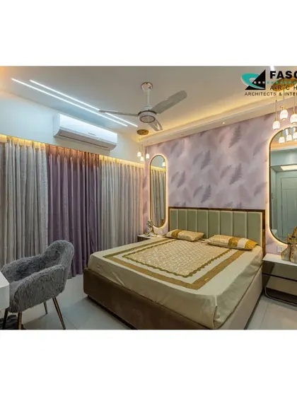 A serene bedroom in Seawoods with a soft green headboard and elegant, backlit oval mirrors. The design uses a gentle color palette and soft lighting to create a peaceful and stylish retreat.