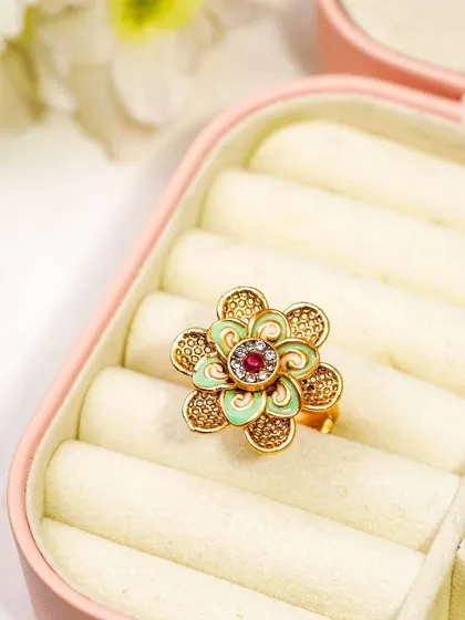 A traditional floral ring styled in a pink jewellery box. The context of the box adds a layer of storytelling, suggesting it as a gift item.