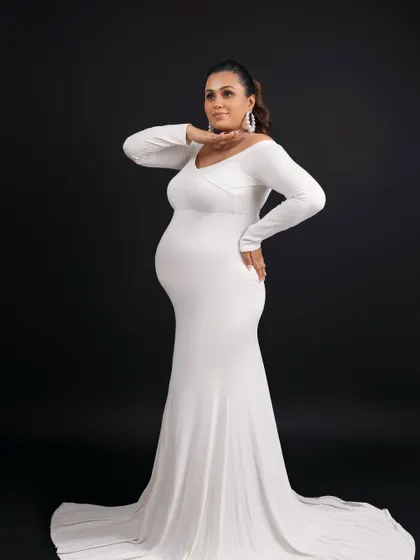 A confident and powerful pose, showcasing the beautiful silhouette of pregnancy.