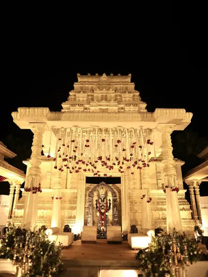 We recreated the grandeur of a South Indian temple for this wedding mandap. The intricate architecture, lit beautifully against the night, provided a sacred and awe-inspiring space for the couple to take their vows, blending tradition with theatrical design.
