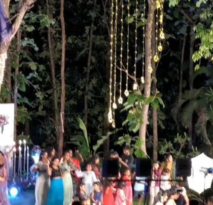 Guests enjoying the music in a magical, rustic wedding venue.