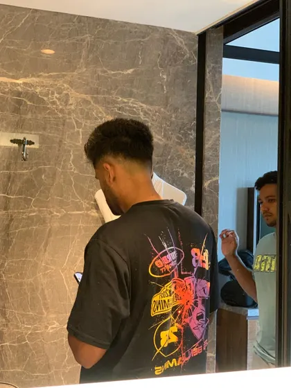 A candid shot during Suryakumar Yadav's haircut.