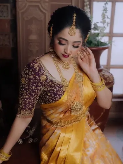 Another view of this stunning custom blouse. The detailed floral and vine embroidery in gold thread makes it a piece of art. We work with you to match the blouse design to your saree and personal style.