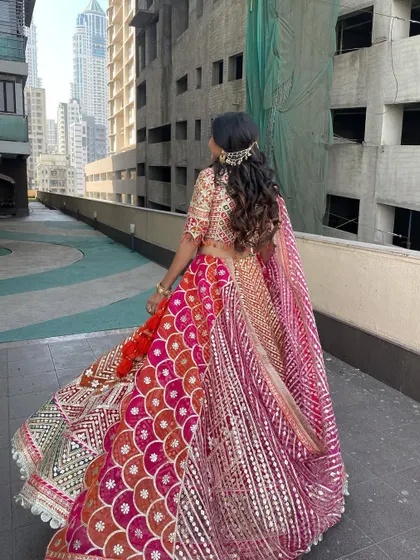 The back view of the half-updo, showing the twirl-worthy lehenga and the beautiful hairstyle.