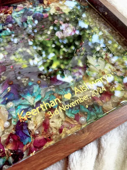 A detail shot showing the custom names and date, Keerthan and Aishwarya, embedded in the resin. These personal touches are what make each keepsake a unique reflection of a couple's love story.