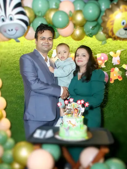 A family poses with their cake during a jungle-themed birthday party. We ensure the cake cutting and surrounding moments are well documented.