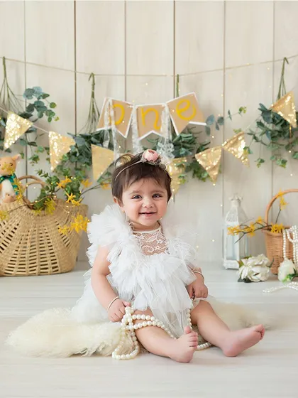 This portrait captures the sweet and happy personality of a baby during her sitter session. The simple, bright setup keeps all the focus on her.