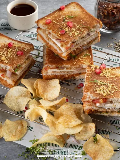 I stacked these sandwiches on a cooling rack to give the shot height and an interesting composition. The scattered chips and dips make it feel like a fun, shareable meal.