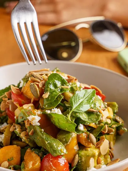 A healthy and delicious mango salad, captured in a lifestyle setting. This image shows how seasonal ingredients can be incorporated into fresh, modern dishes.