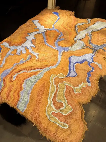 An abstract textile landscape from 'Cu+Fibers', rich in color and texture. This piece is an example of our improvisational approach, where the material guides the final form.