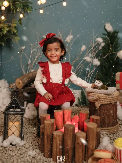A sweet smile from the little girl as she sits by the cozy campfire.