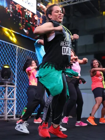 A group shot from the IHFF stage, showing the power of moving together. The collective energy of a group class is what makes the workout so effective and fun.
