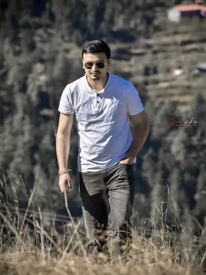 An action shot of a man walking through a field. This dynamic style of portraiture feels natural and tells more of a story than a static pose.