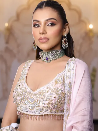 The full half-up, half-down hairstyle with soft waves perfectly complements this romantic engagement look.