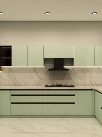 A spacious U-shaped kitchen in a soothing sage green. The design features a marble backsplash and countertop, with handleless cabinets for a clean, seamless appearance.