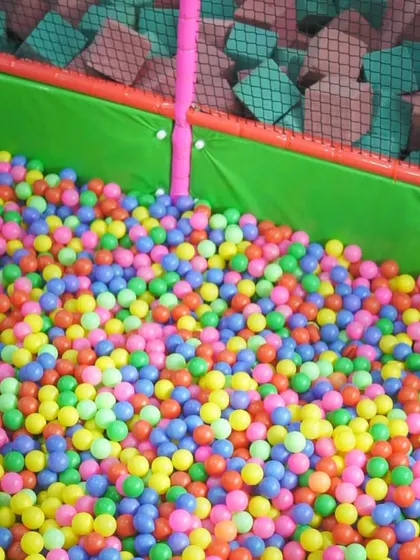 A close-up of our ball pit, filled with thousands of bright, clean, and colorful balls.