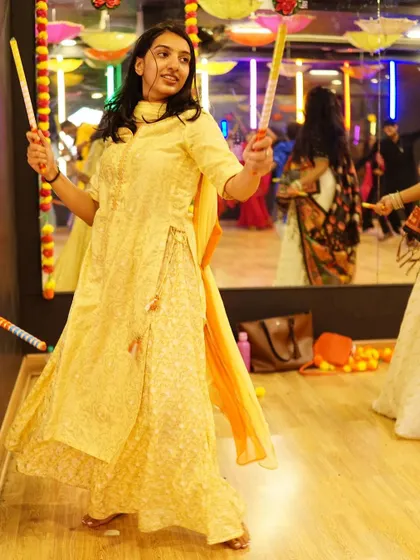 A dancer practicing with her dandiya sticks. We teach the proper techniques for handling the sticks safely and rhythmically.