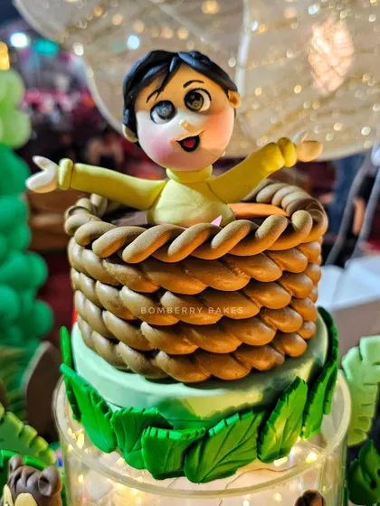 This topper features a little boy in a hot air balloon basket, ready for a jungle adventure. It's a great way to make the birthday child the star of their own cake.