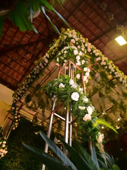 A low-angle shot of a floral arch, showing the intricate details of the flower arrangements. We use high-quality flowers to ensure the decor looks fresh and beautiful.