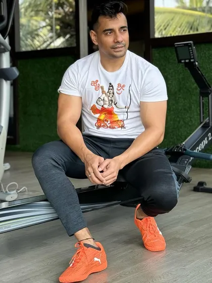 A member takes a moment to rest on a rowing machine, showcasing the blend of hard work and thoughtful recovery that is part of our training philosophy.