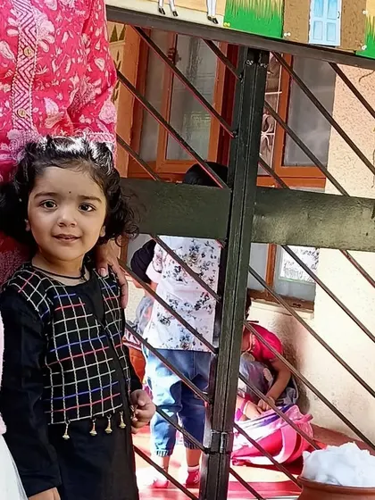 Two little girls standing by our Pongal decorations.