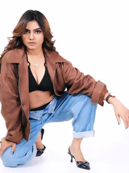 A full-body shot of the same casual look, showing a dynamic kneeling pose. This demonstrates the model's ability to pose and interact with the space around her.