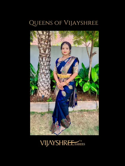Manasa Gowda looking regal in a deep blue Banarasi-style Kanjivaram. The intricate weaving and the traditional gold jewelry pairing create a truly royal look.