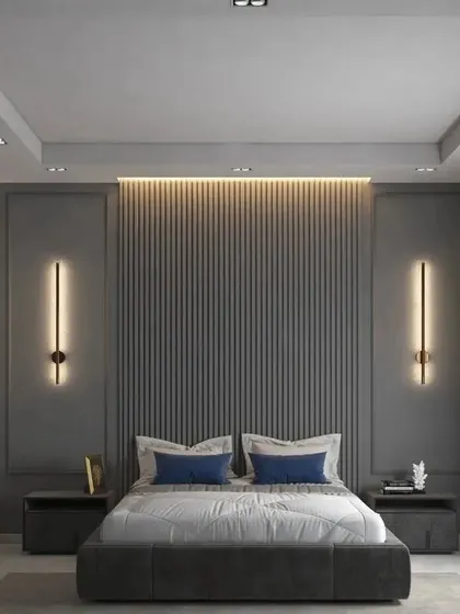 A direct view of the bed and feature wall, showing the symmetry of the design with flanking bedside tables and elegant wall sconces.