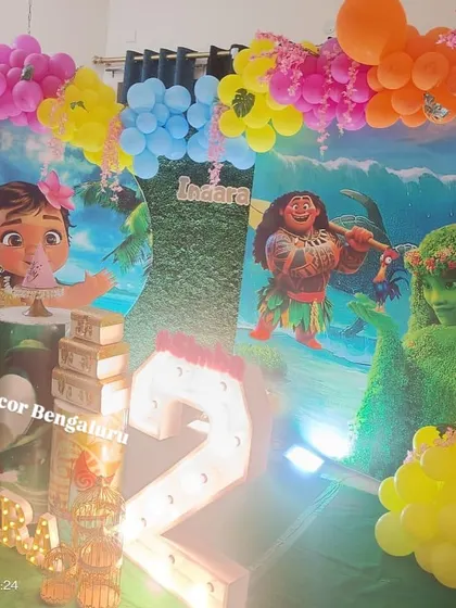 This vibrant Moana setup shows how we can transform a space into a tropical paradise. The colorful balloon garland and large backdrop make you feel like you're right on the island.