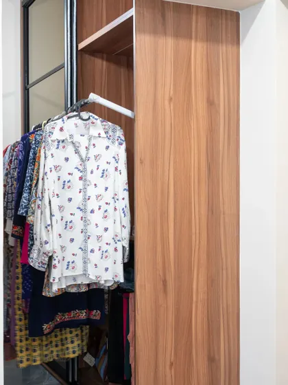 The interior of the sliding wardrobe, showing a pull-down clothing rail, which makes it easy to access items stored in the upper section.