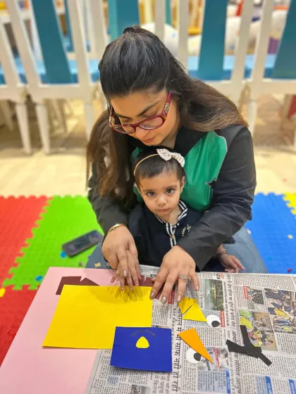 A mother and daughter carefully work on their craft project, a great example of the quiet, focused activities we offer.