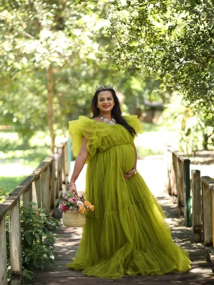 A solo portrait of the mom-to-be. She looks like a queen in her green tulle gown, and the makeup is soft and regal.