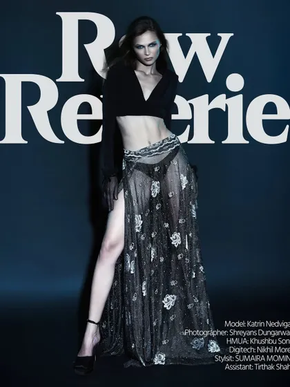 A powerful, full-length pose. The lighting from the side highlights the model's leg and torso, creating a strong, defined shape.