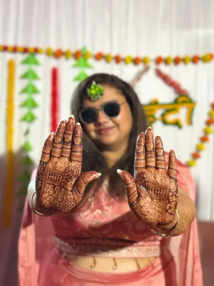 A closer look at the intricate patterns on her hands, ready for the festivities.
