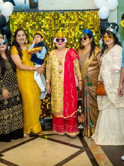 The fun isn't just for kids. Here's a whole family getting into the spirit with silly wigs and glasses in front of a shimmery photo backdrop.