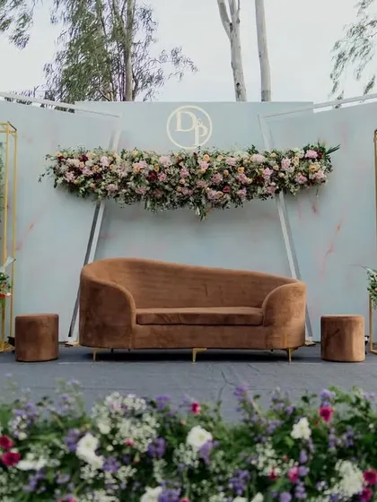 The full view of our modern pastel engagement stage, showing how the floral arrangements at the base and on the structure create a complete and cohesive picture.