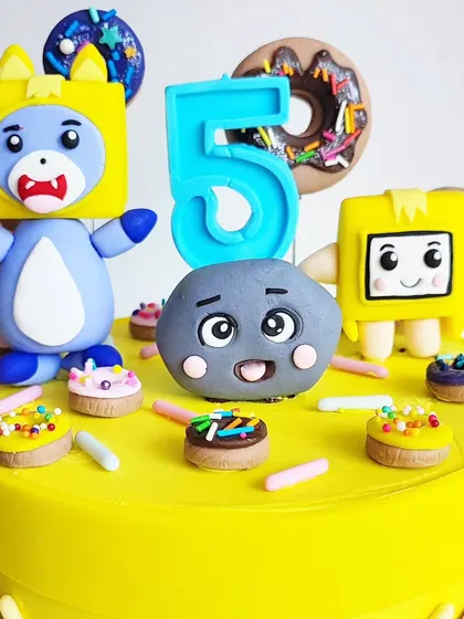 A close-up on the handcrafted toppers for the Lanky Box cake. Every detail is made with care to perfectly capture the characters for the birthday boy.