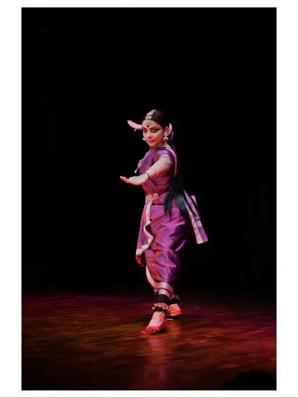 The striking silhouette of Sandhya Udupa against the stage lights.